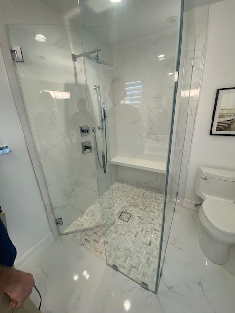 Glass shower with bench and herringbone floor