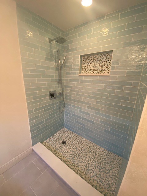 Blue subway-tile shower with decorative niche